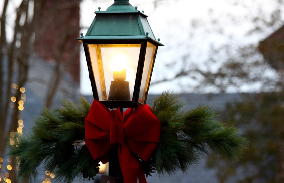 The Warmth of Community | Image of holiday decorated street lamp