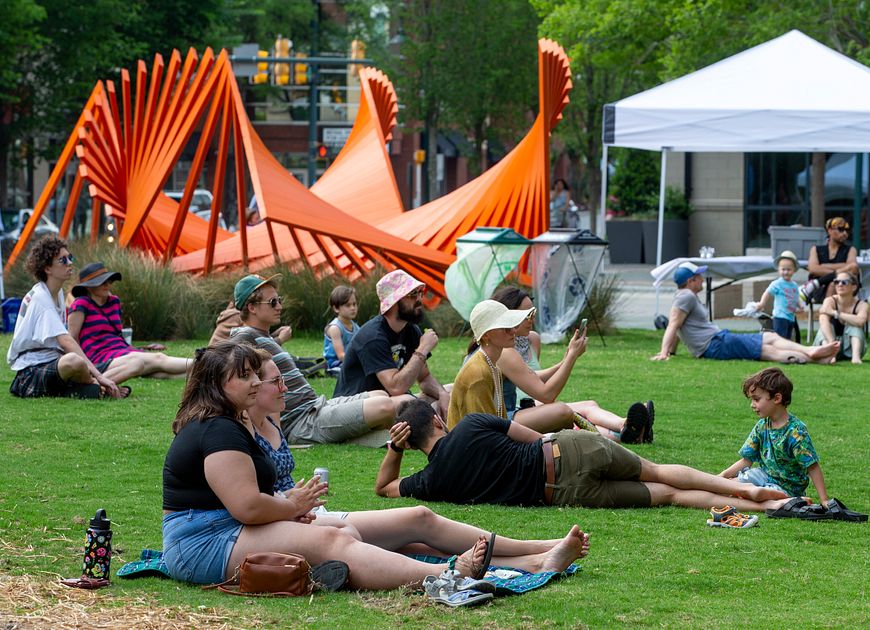 Recreation and Outdoor Life | Young People sitting on a lawn surrounded by art