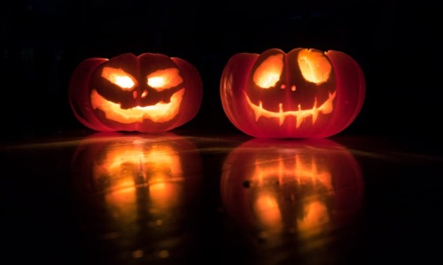 Apartment Amenity | Two glowing jack-o'-lanterns at night