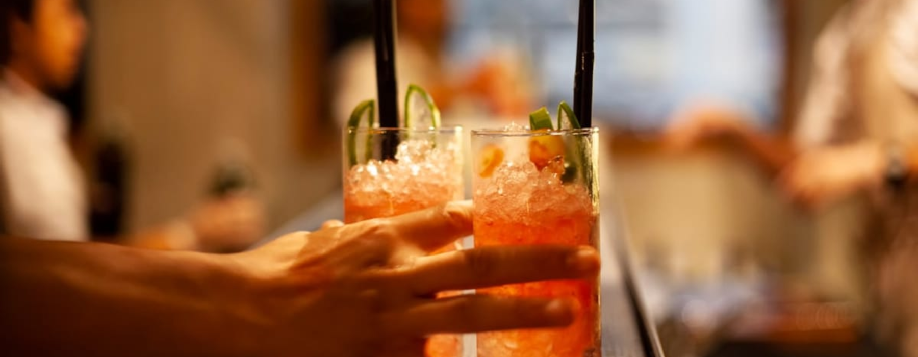 Top Local Happy Hours | Image of person holding cocktail beverages