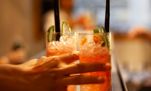 Top Happy Hours Within Walking Distance of Atlas Blue Hill Top Local Happy Hours | Image of person holding cocktail beverages